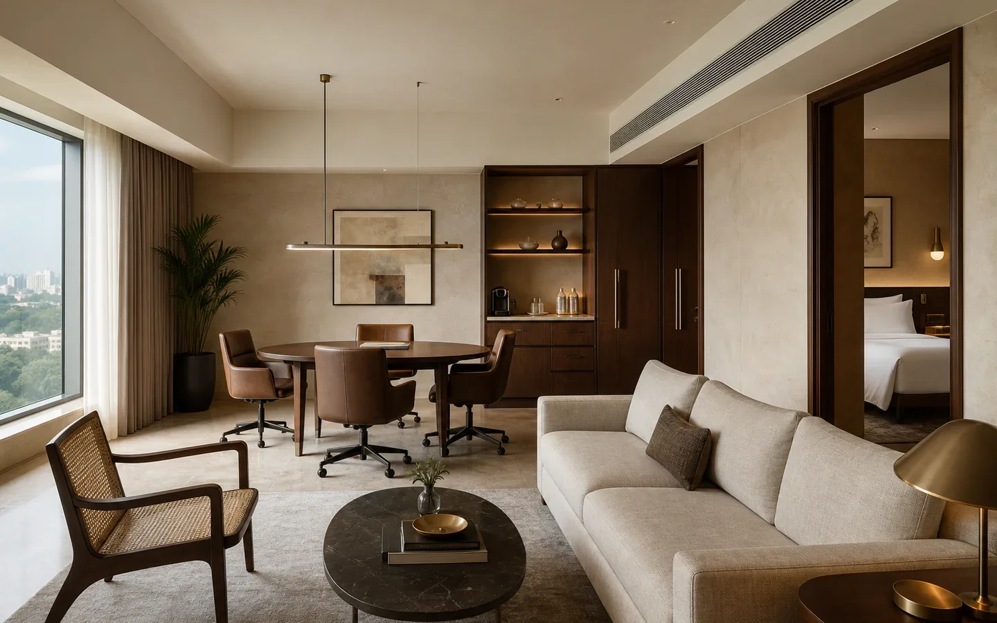 Fivestar Hotel Business Suite living room with a meeting table and bedroom beyond