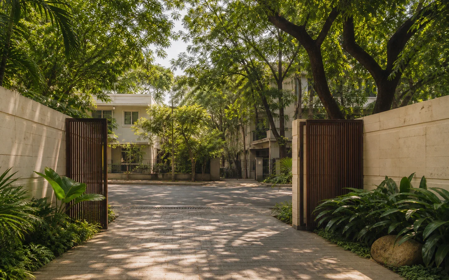 Fivestar Hotel landscaped gate opening onto a quiet tree-lined Chennai street